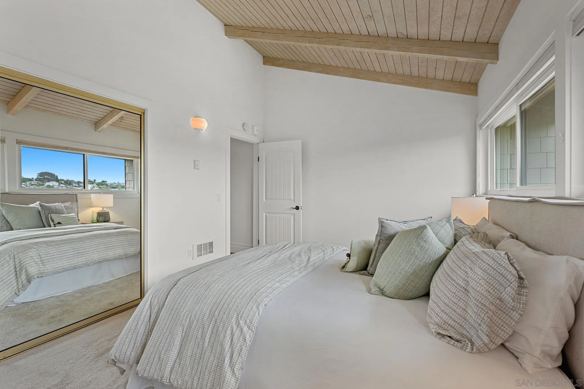 337 West I Street Encinitas, CA 92024 - Photo 28 of 58 a bedroom with a large bed and a couch