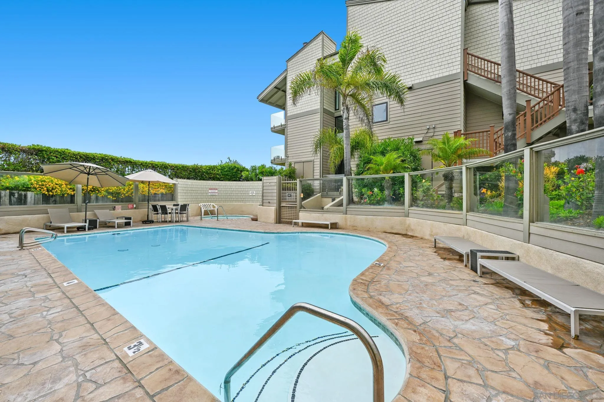 337 West I Street Encinitas, CA 92024 - Photo 45 of 58 a view of a swimming pool with a lounge chairs