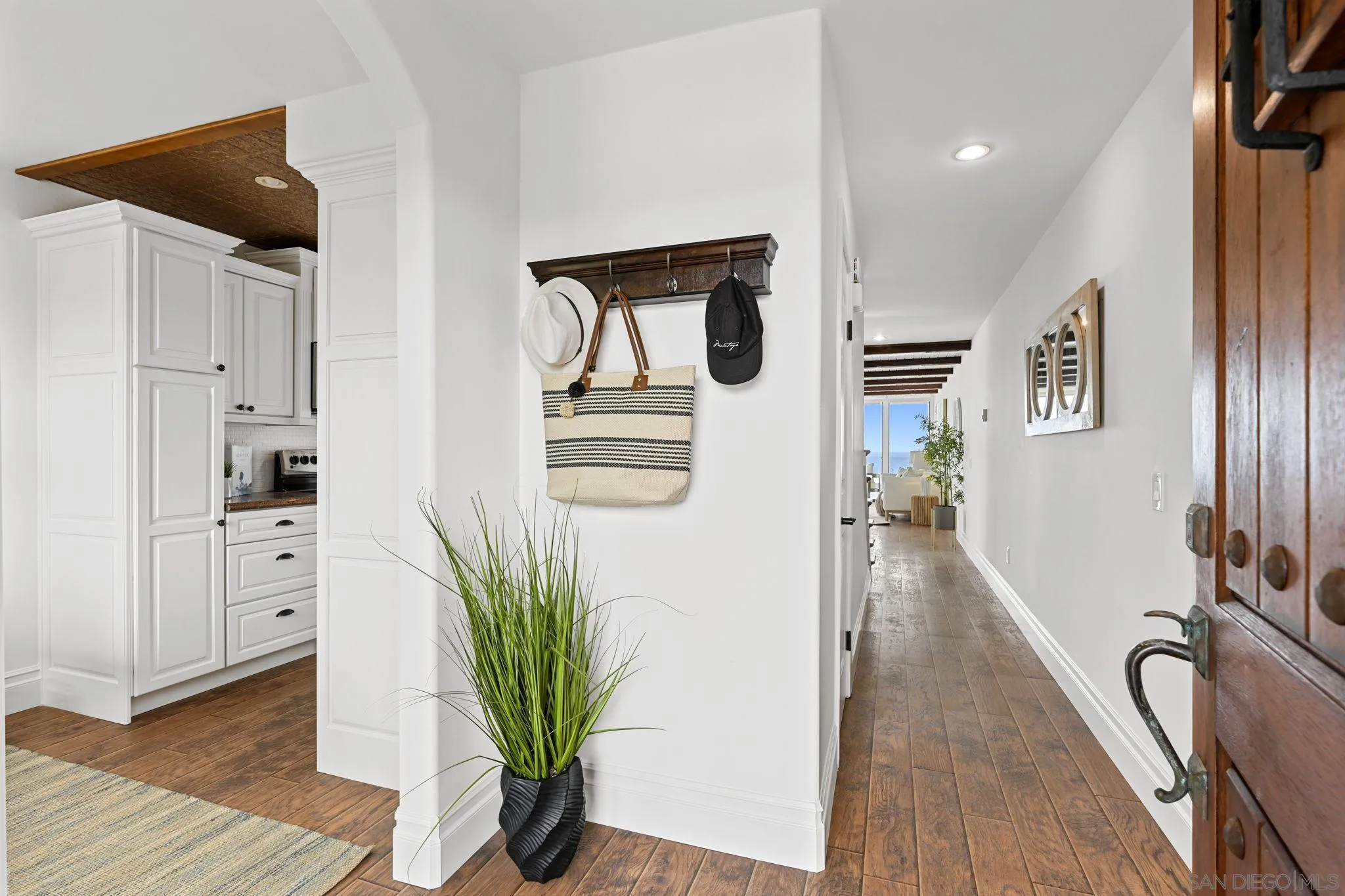 337 West I Street Encinitas, CA 92024 - Photo 5 of 58 a hallway with white cabinets and wooden floor