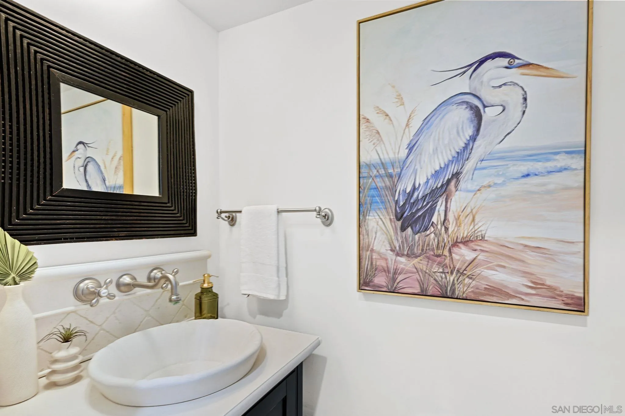 337 West I Street Encinitas, CA 92024 - Photo 8 of 58 a bathroom with a toilet sink and mirror