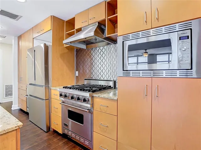 an empty room with wooden floor and sliding door