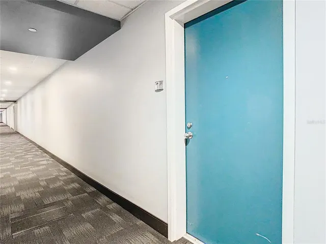 a kitchen with kitchen island granite countertop a sink a counter space appliances and cabinets