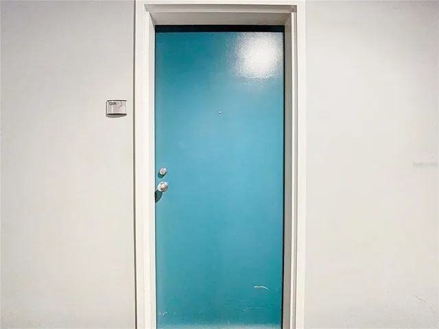 a metallic refrigerator freezer and a stove sitting inside of a kitchen