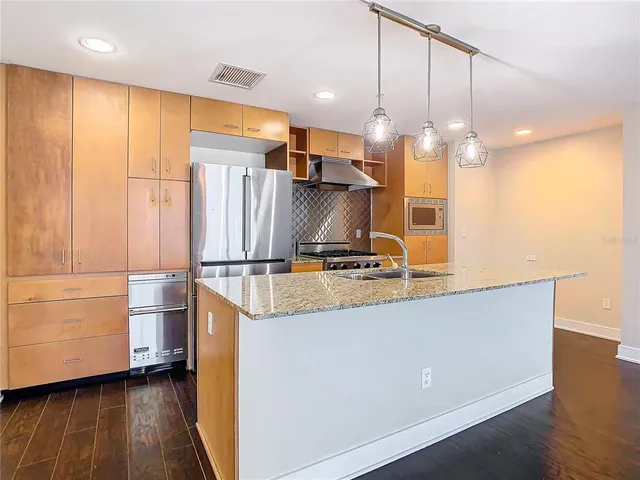 a kitchen with granite countertop a sink and a chandelier