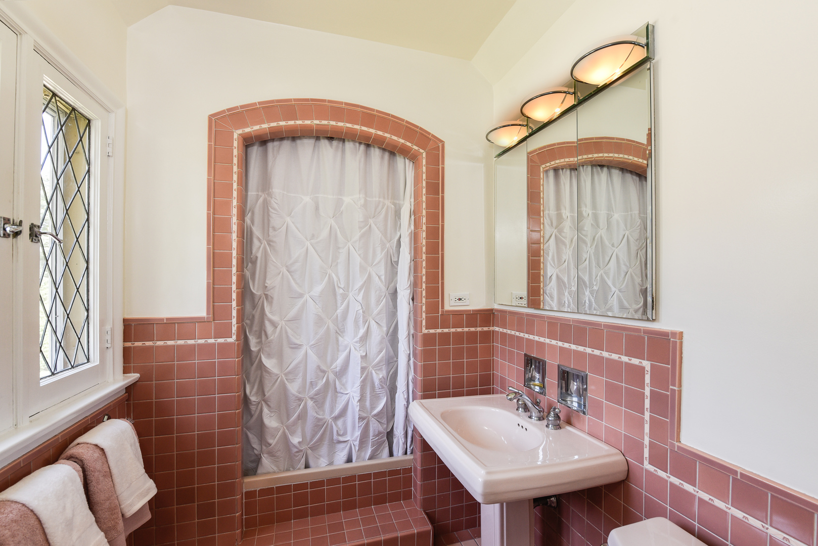 411 Ridge Road Kenilworth, IL 60043 - Photo 25 of 35 a bathroom with a sink a mirror and a shower