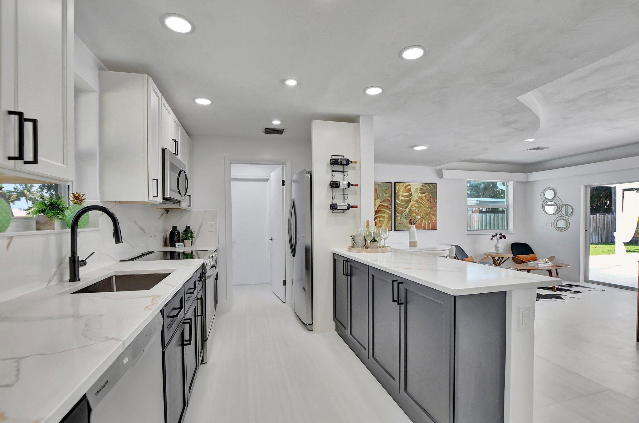 832 Southwest 10th Avenue Boca Raton, FL 33486 - Photo 7 of 57 a kitchen with a sink stove top oven and refrigerator
