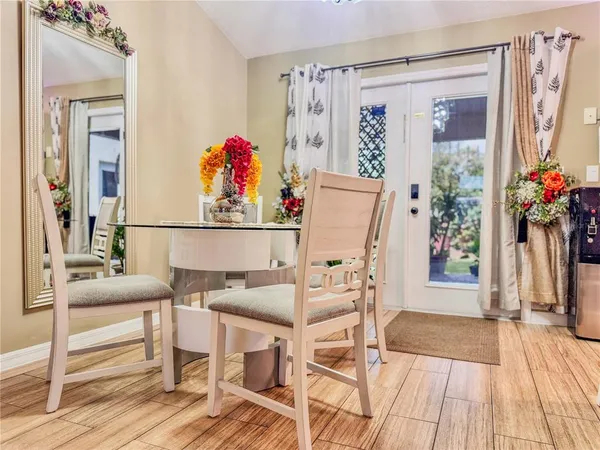 a dining room with furniture and a entryway