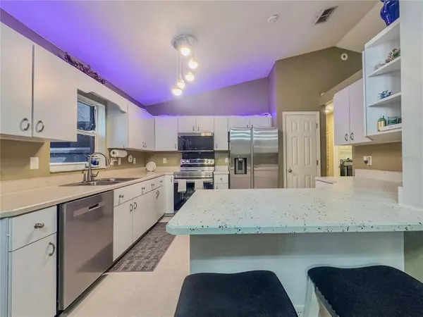 a kitchen with cabinets and appliances