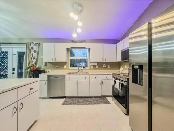a kitchen with granite countertop appliances cabinets and a sink