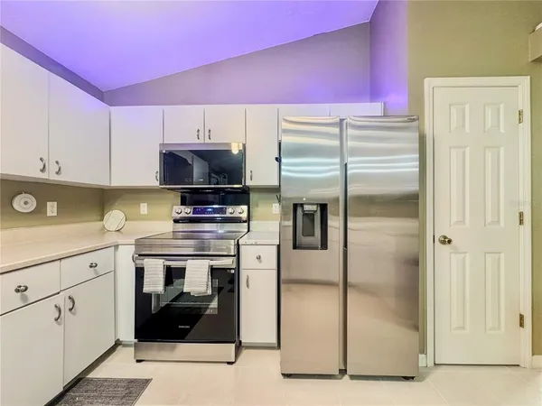 a kitchen with stainless steel appliances a refrigerator sink and cabinets