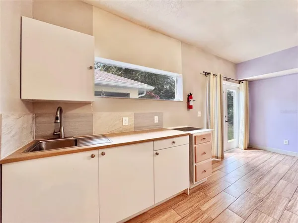 a view of a swimming pool with lawn chairs under an umbrella