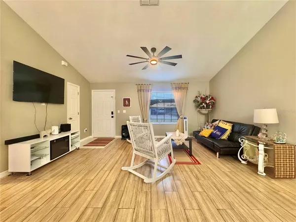 a living room with furniture and a flat screen tv