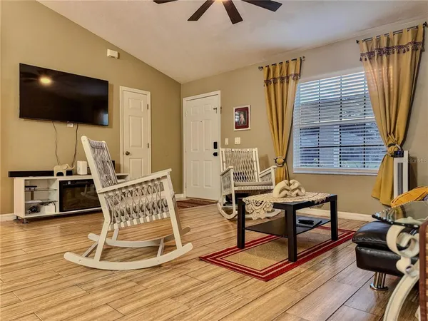 a living room with furniture and a flat screen tv