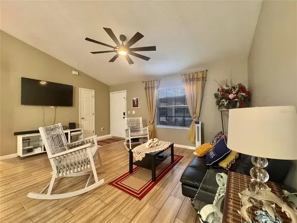 a living room with furniture and a flat screen tv