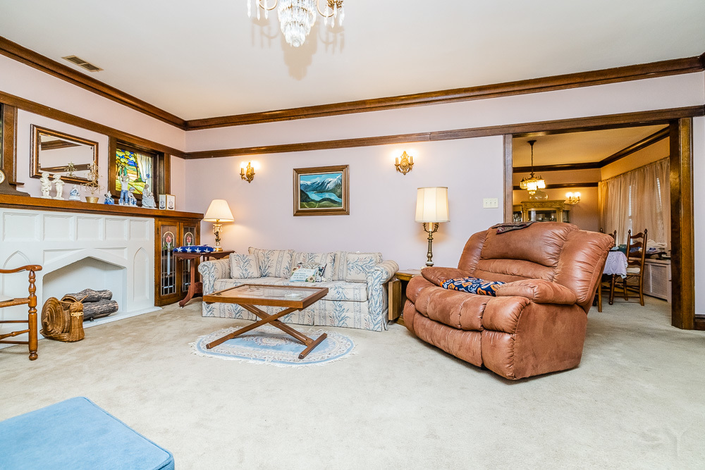 2933 Maple Avenue Berwyn, IL 60402 - Photo 8 of 49 a living room with furniture a fireplace and a large window
