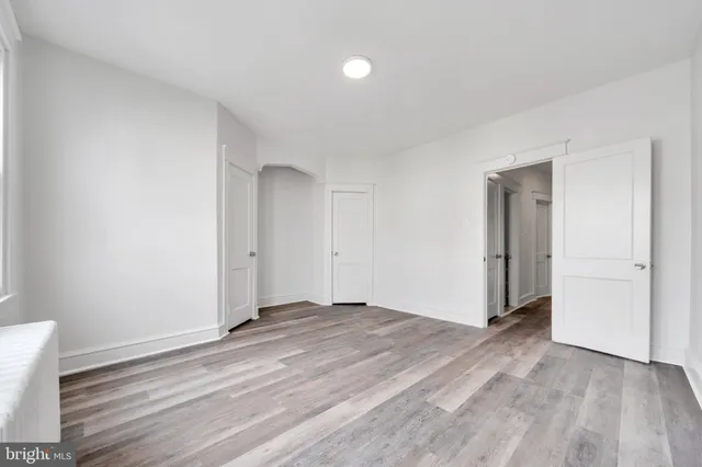 a view of an empty room and wooden floor