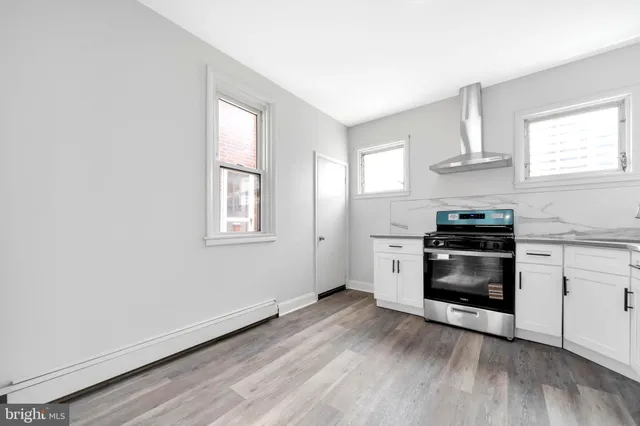 a kitchen with granite countertop a stove and a window