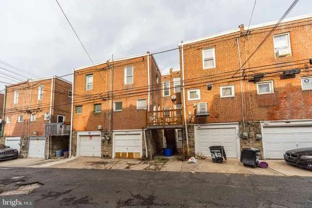 a front view of a building with parking space