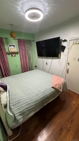 a bedroom with a bed next to a window with outer view