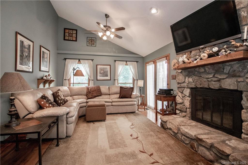 8869 Holdsclaw Road Terrell, NC 28682 - Photo 13 of 37 a living room with furniture a flat screen tv and a fireplace