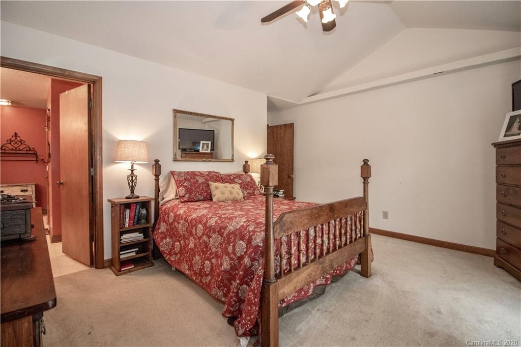 8869 Holdsclaw Road Terrell, NC 28682 - Photo 14 of 37 a bed room with a bed and a chandelier