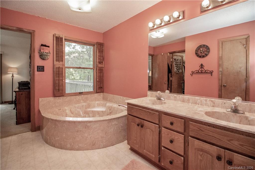 8869 Holdsclaw Road Terrell, NC 28682 - Photo 17 of 37 a spacious bathroom with a tub sink and mirror