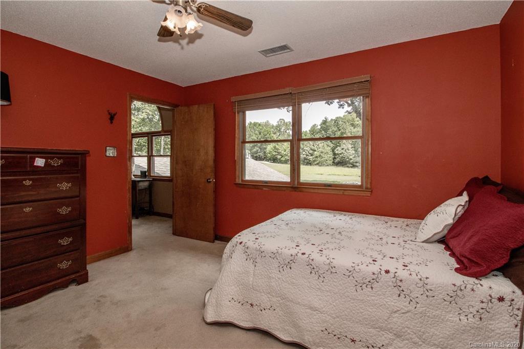 8869 Holdsclaw Road Terrell, NC 28682 - Photo 20 of 37 a bedroom with a bed and a dresser