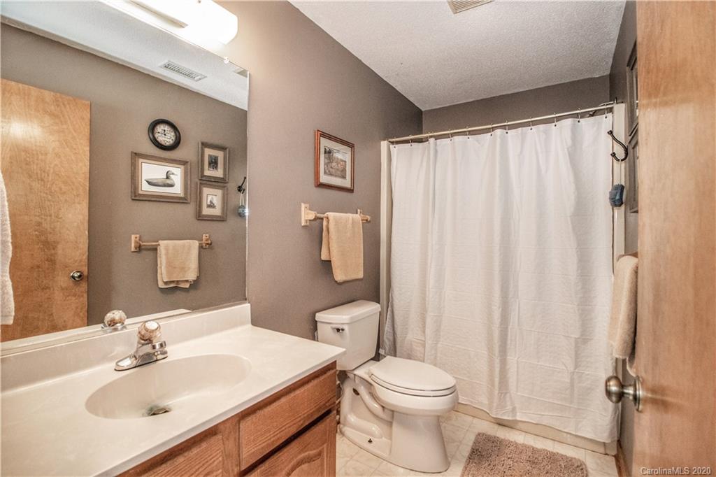 8869 Holdsclaw Road Terrell, NC 28682 - Photo 21 of 37 a bathroom with a sink toilet and shower