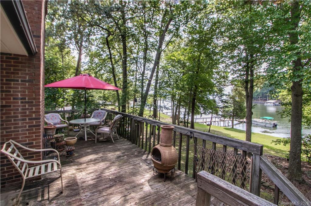 8869 Holdsclaw Road Terrell, NC 28682 - Photo 27 of 37 a view of a patio with chairs and table under an umbrella