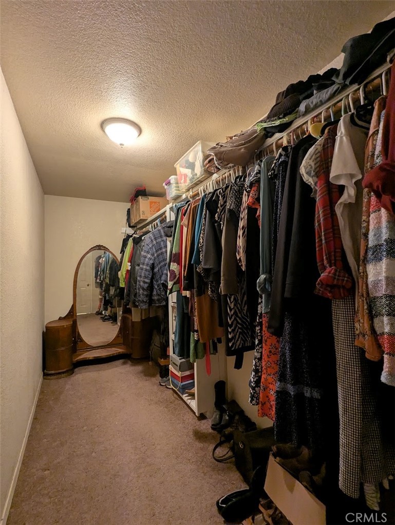 2304 Hutton Way Durham, CA 95938 - Photo 30 of 43 a view of walk in closet with clothes and shoes