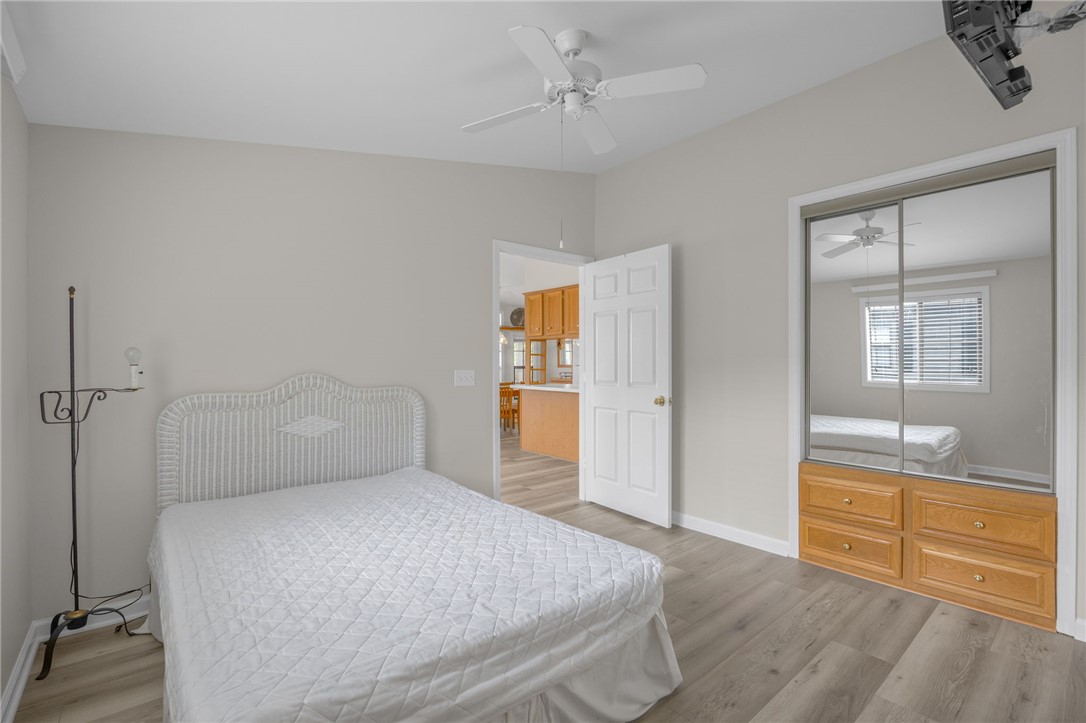 1230 Melton Road, Unit 25 West Union, SC 29696 - Photo 8 of 46 Hardwood-style flooring extends into a well-lit bedroom featuring a convenient mirrored closet.