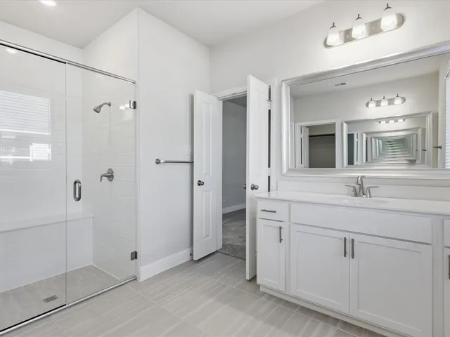 a bathroom with a granite countertop sink mirror and a bathtub
