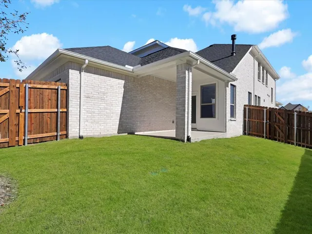 a view of a house with wooden fence