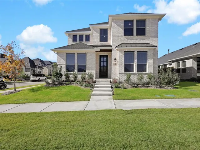 a front view of a house with a yard table and chairs