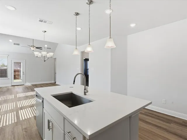 a kitchen with a stove a microwave and cabinets