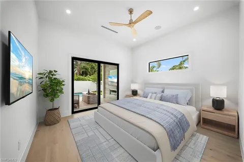 a bedroom with a large bed and a large window