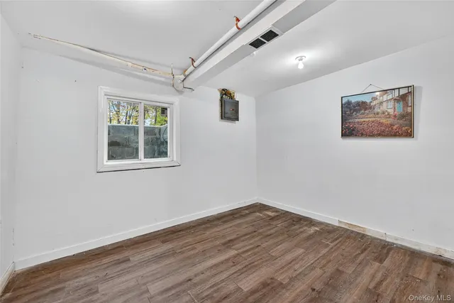 a view of a room with wooden floor and window