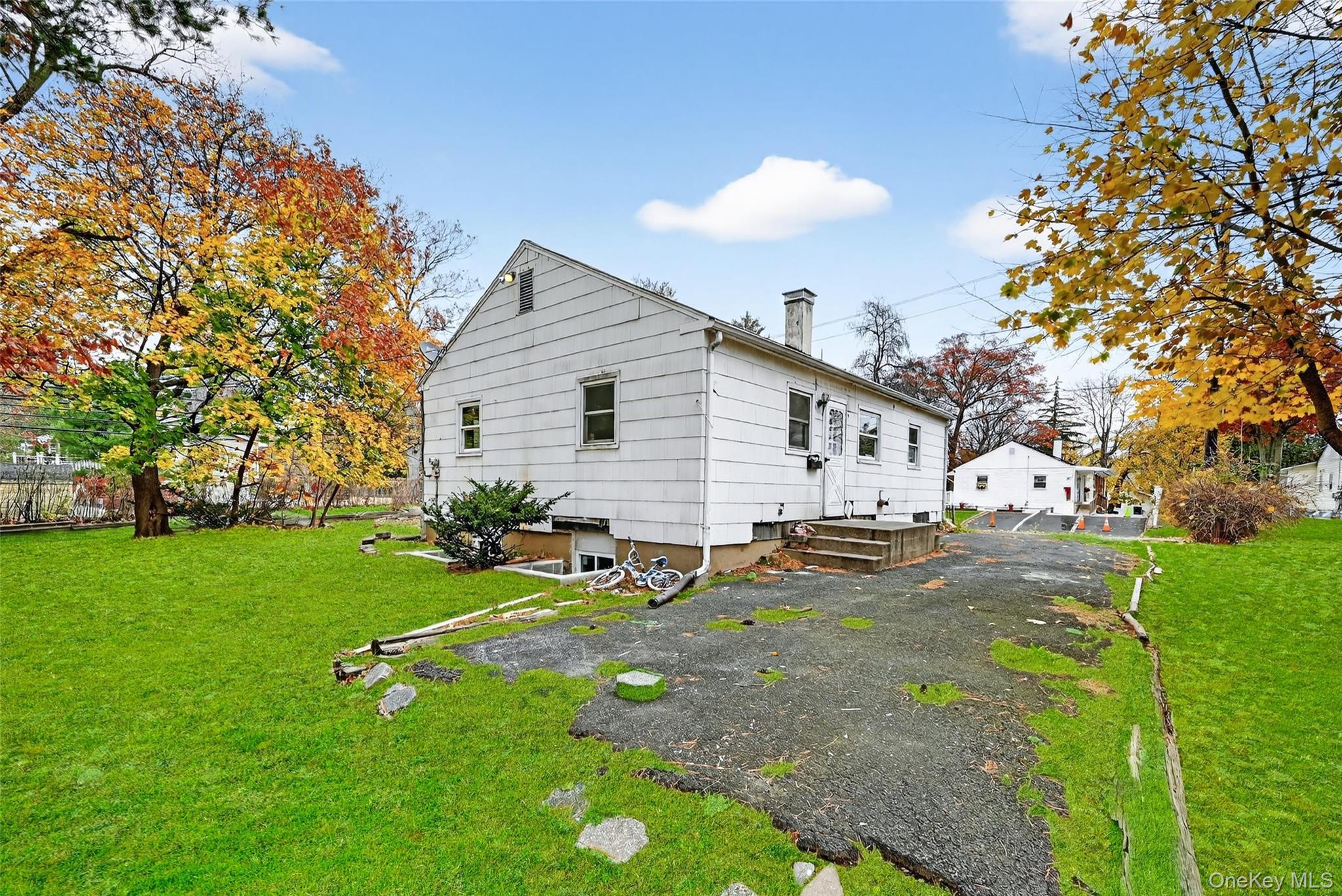 106 East Eckerson Road Spring Valley, NY 10977 - Photo 30 of 33 a view of a white house with a yard and sitting area