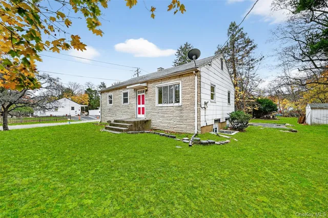 a front view of house with yard and green space