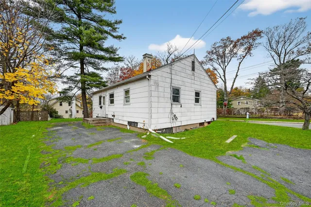 a view of a white house with a yard