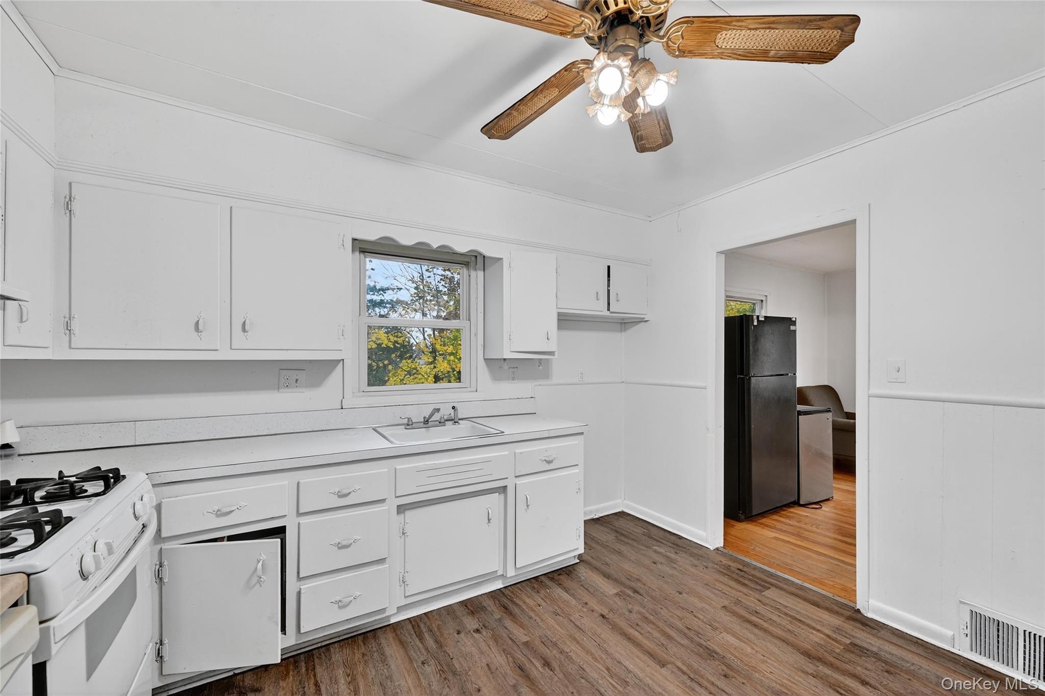 106 East Eckerson Road Spring Valley, NY 10977 - Photo 5 of 33 a kitchen with a white cabinets and chandelier