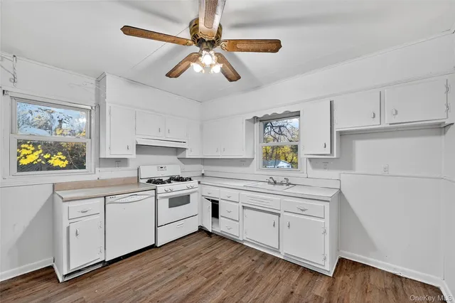 a kitchen with a white cabinets and white appliances