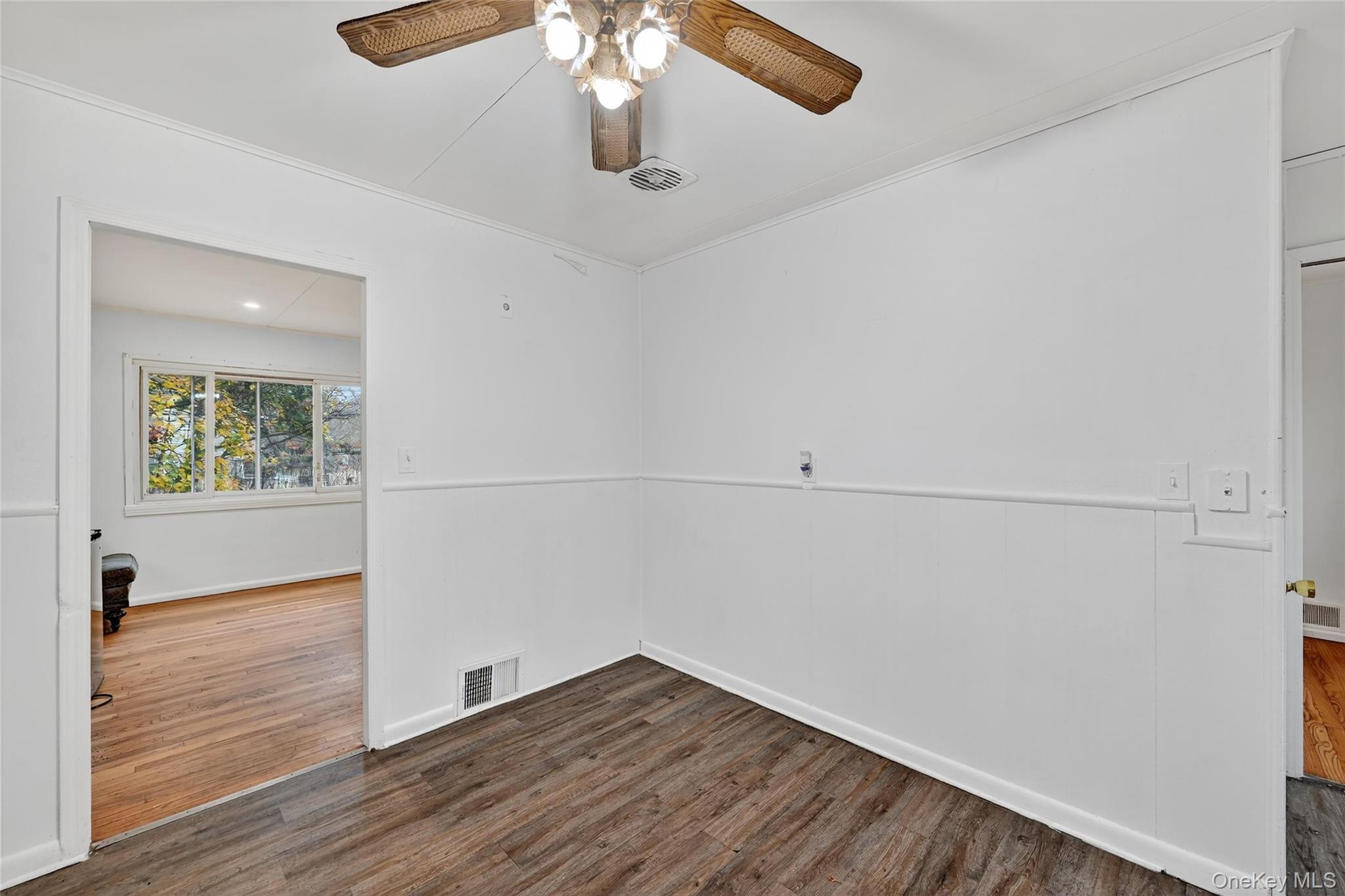 106 East Eckerson Road Spring Valley, NY 10977 - Photo 9 of 33 an empty room with wooden floor fan and windows