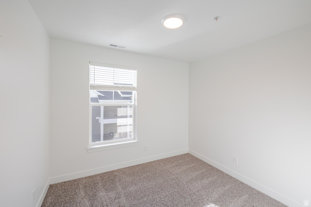 4662 Poplar Way, Unit Q302 Mapleton, UT 84664 - Photo 9 of 17 Empty room with baseboards and light colored carpet