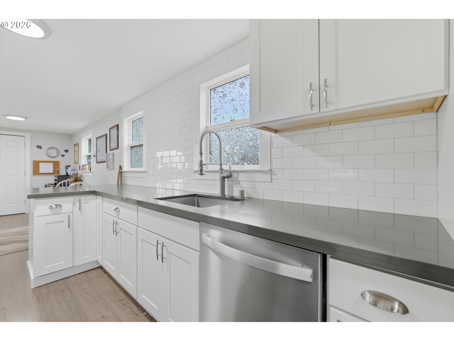 285 19th Avenue Longview, WA 98632 - Photo 12 of 27 a kitchen with white cabinets a sink and dishwasher