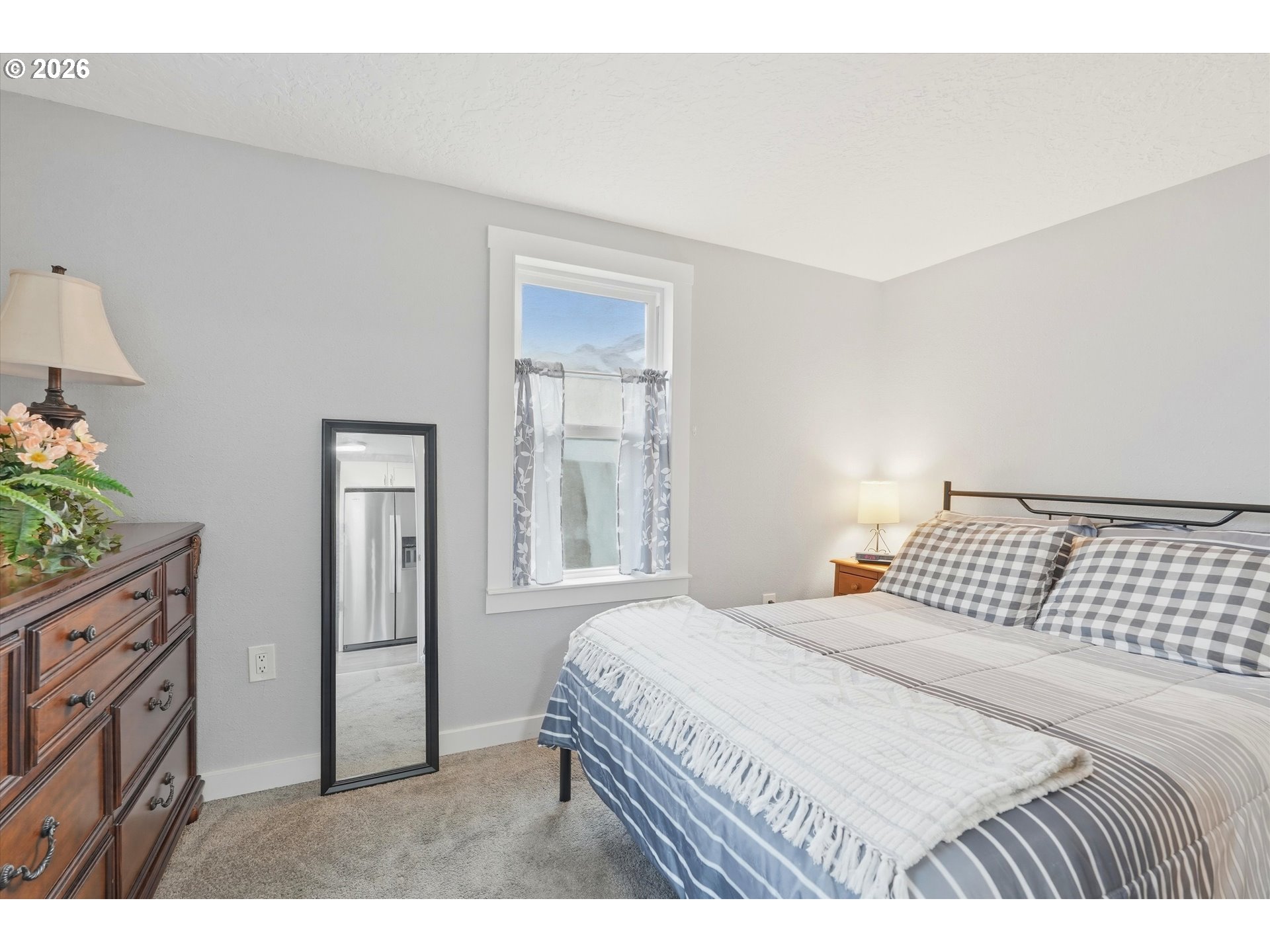 285 19th Avenue Longview, WA 98632 - Photo 13 of 27 a bedroom with a bed and a lamp on dresser