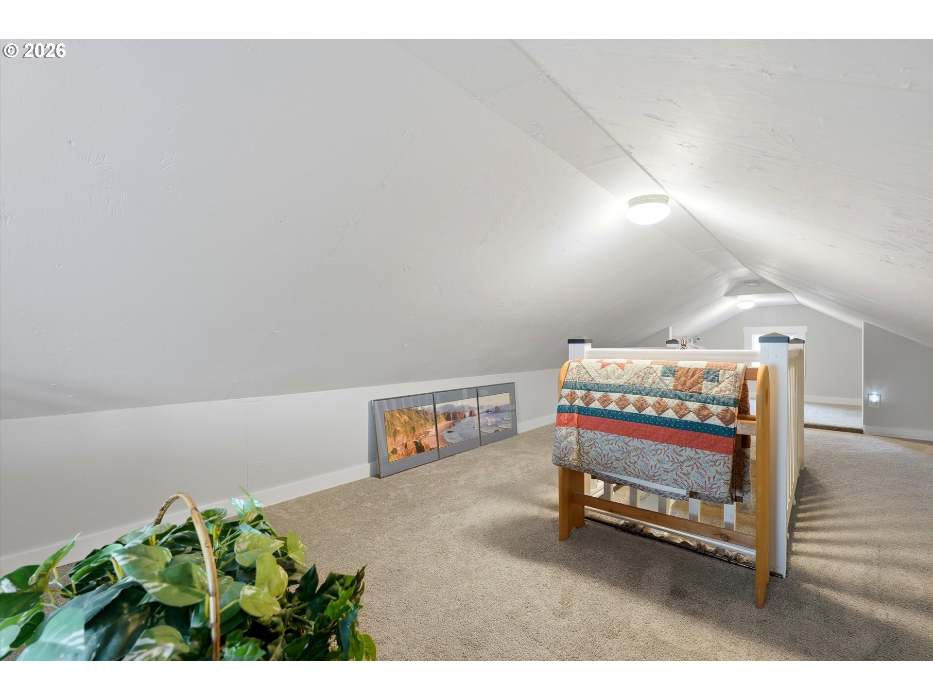 285 19th Avenue Longview, WA 98632 - Photo 18 of 27 a bedroom with furniture and a potted plant