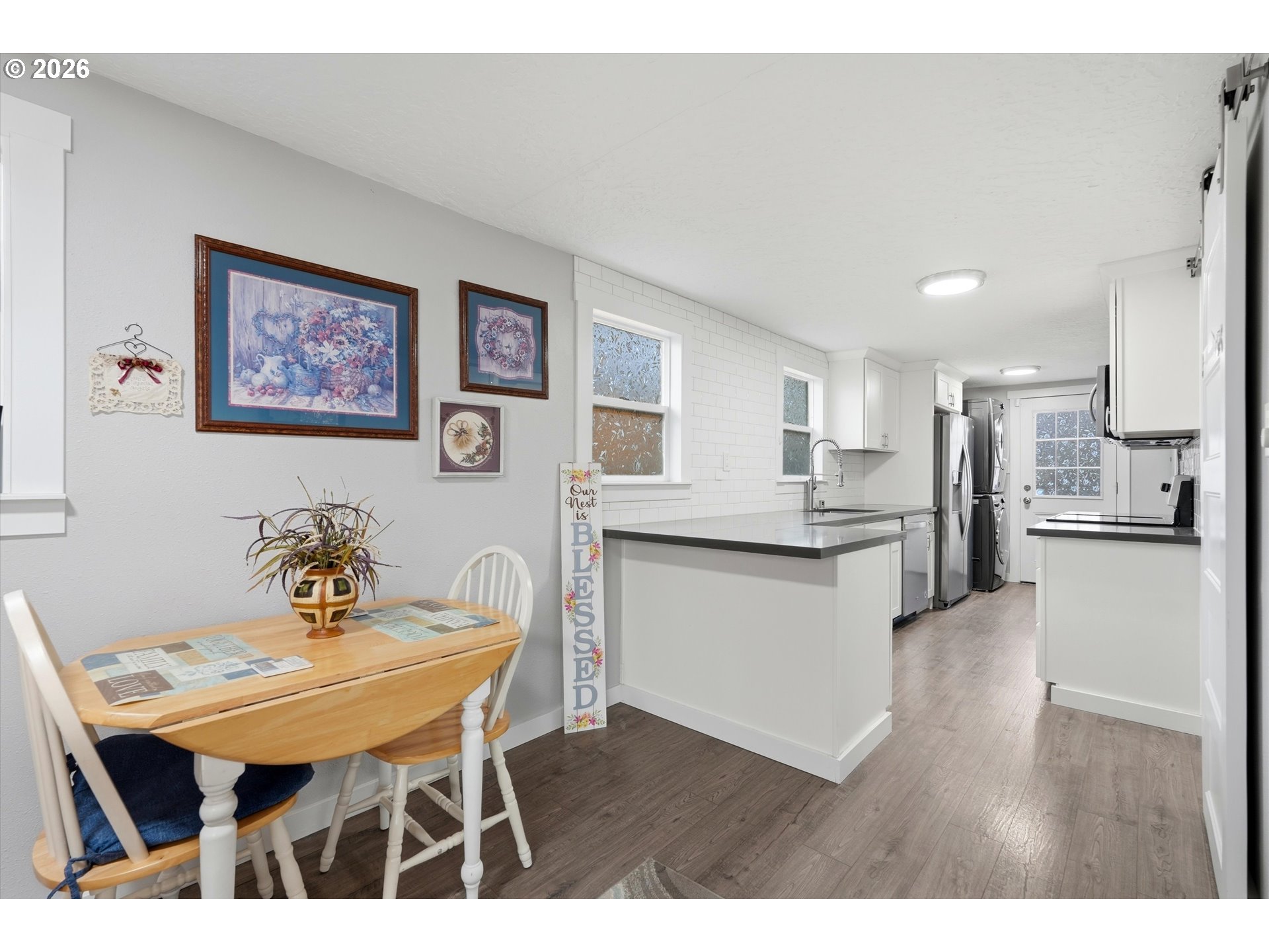 285 19th Avenue Longview, WA 98632 - Photo 9 of 27 a kitchen with stainless steel appliances kitchen island granite countertop a table chairs and a refrigerator