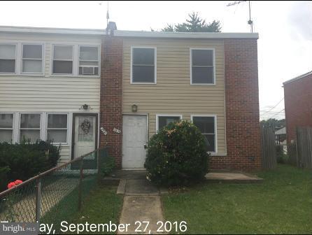 7929 Wynbrook Road Baltimore, MD 21224 - Photo 1 of 10 a view of a house with many windows next to yard