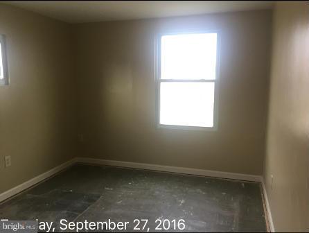 7929 Wynbrook Road Baltimore, MD 21224 - Photo 5 of 10 an empty room with a window